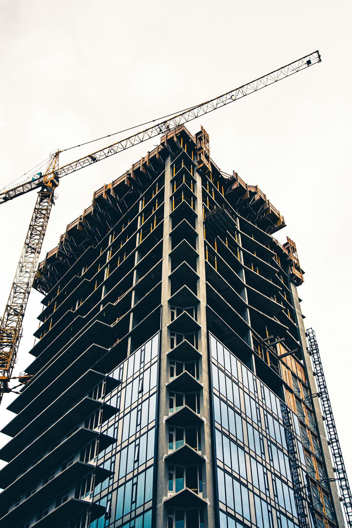 Construction crane over a building under development in black and white